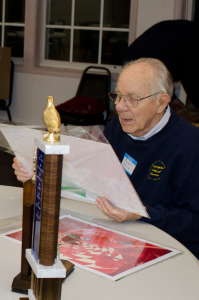 Roland Smith reviewing prints at the PPS Potluck in June, 2014 - Photo by Pat Fitzgerald